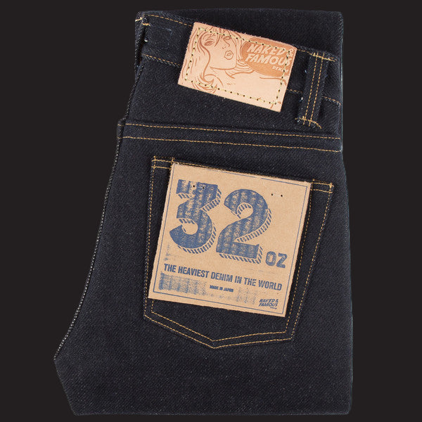 Dark blue jeans with a brand label and weight information(32oz)